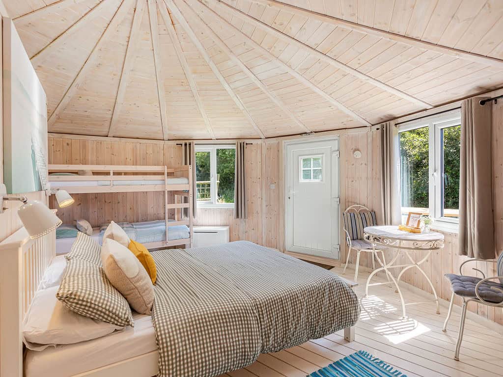 Family cabin interior with king-size bed and bunk beds